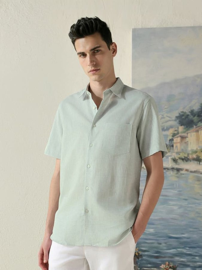 Catalogue model in a mint shirt, sea painting behind