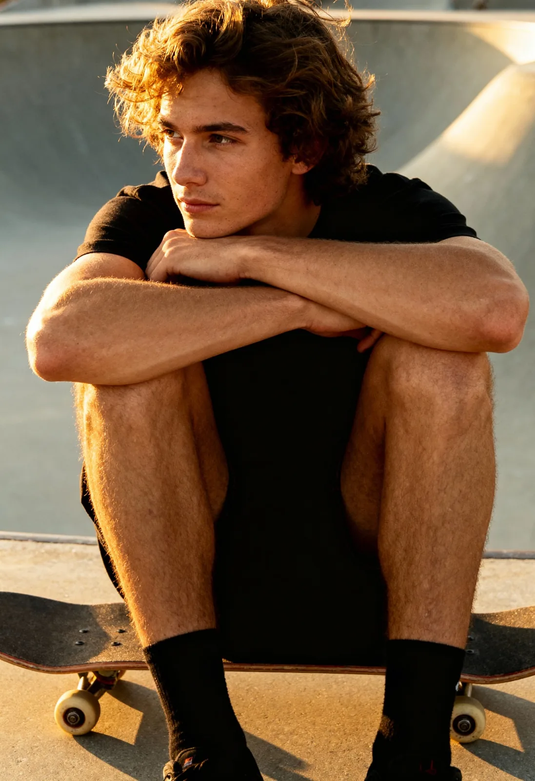 Before: man crouching on a skateboard in a black T-shirt